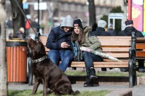 The guy with the girl sitting on a bench