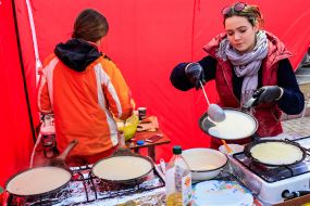 The seller fries pancakes