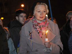 Woman holding a lighted candle in her hands