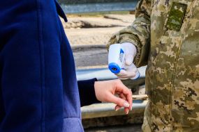 Border guards carry out temperature checks of citizens crossing the border
