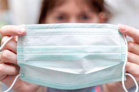 Woman holds medical mask