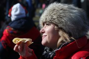 Woman holds pancake in hand