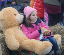 The girl sits on a big toy bear