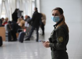 Airport employee with a thermometer