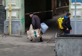 Glovo delivery courier and elderly man with bag and waste paper in hand