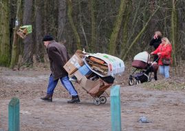 A man carries a cart with waste paper
