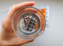 Woman holds pills in her hand