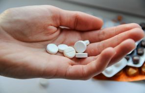 Woman holds pills in her hand