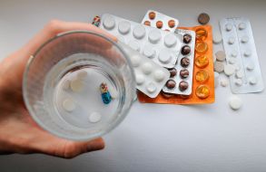 Woman holds pills in her hand