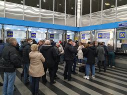 People stand in queues for return tickets at the Central railway station