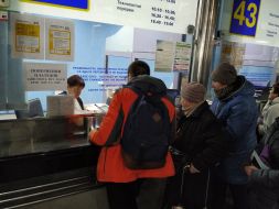 People stand in queues for return tickets at the Central railway station