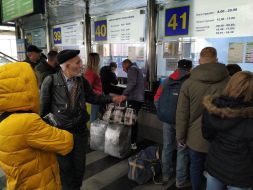 People stand in queues for return tickets at the Central railway station