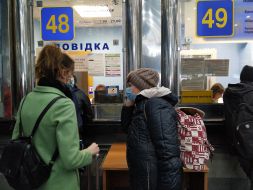 People stand in queues for return tickets at the Central railway station