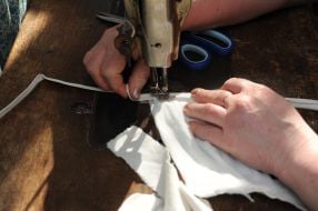 Woman sews medical mask