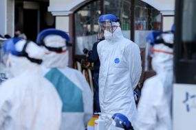 Специалисты в защитных  костюмах