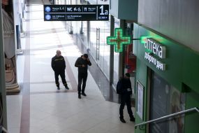 People stand in line at the pharmacy.