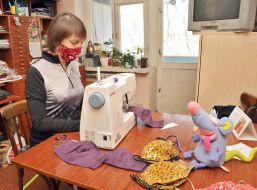 Woman sews protective mask