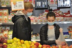 Young people choose goods in a grocery store