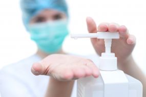 The medical worker washes hands with an antiseptic