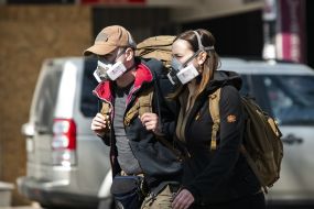 Man and woman in respirators