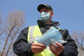 A police officer holds a medical mask