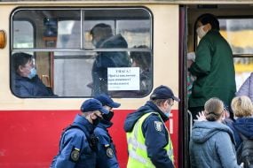 Law enforcement officers together with National Guard troops patrol the street