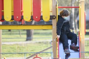 The boy descends from the slide at the playground in Kiev