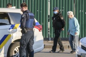 Law enforcement officers stopped an elderly woman on the street