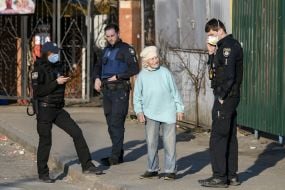 Law enforcement officers stopped an elderly woman on the street