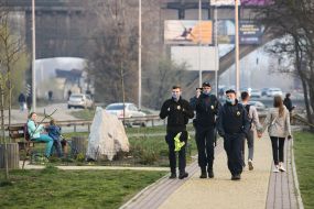 Law enforcement officers together with National Guard troops patrol the street