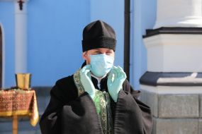 A clergyman in a medical mask