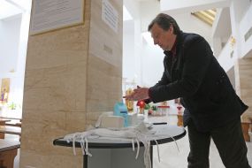 The parishioner sanitizes his hands in the church of St. Basil the Great