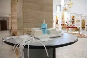 Table with medical masks and disinfectant in St. Basil the Great Temple