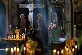 Believer in the medical mask in St. Michael's Cathedral