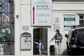 Woman with baby in medical mask