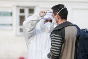 Medical worker conducts temperature screening