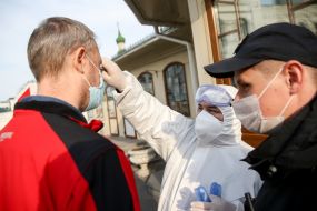 Medical worker conducts temperature screening