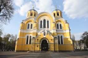 Believer puts a candle on a candlestick