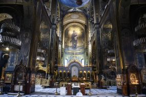 Believer puts a candle on a candlestick
