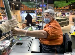 Supermarket cashier in mask