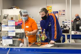 Supermarket cashier in mask