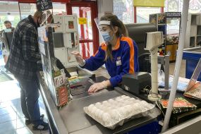 Supermarket cashier in mask