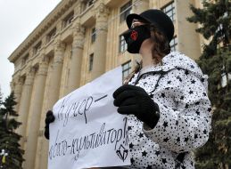 A rally participant holds a poster