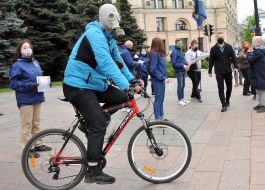 A rally participant sits on a bicycle