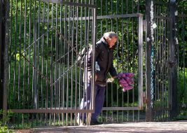 A man comes out with a bouquet of lilacs from the botanical garden
