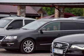 People in cars on the roof of the parking lot