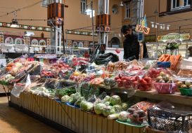 Vendor in the vegetable department at the Bessarabian market in Kyiv