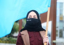 The participant of the action holds the flag of the Crimean Tatars