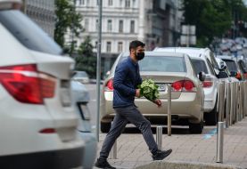 A man carries a bouquet of lilies of the valley