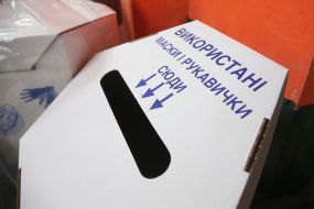 Container with used masks and gloves